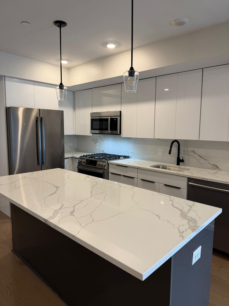 A polished white quartz kitchen island after cleaning