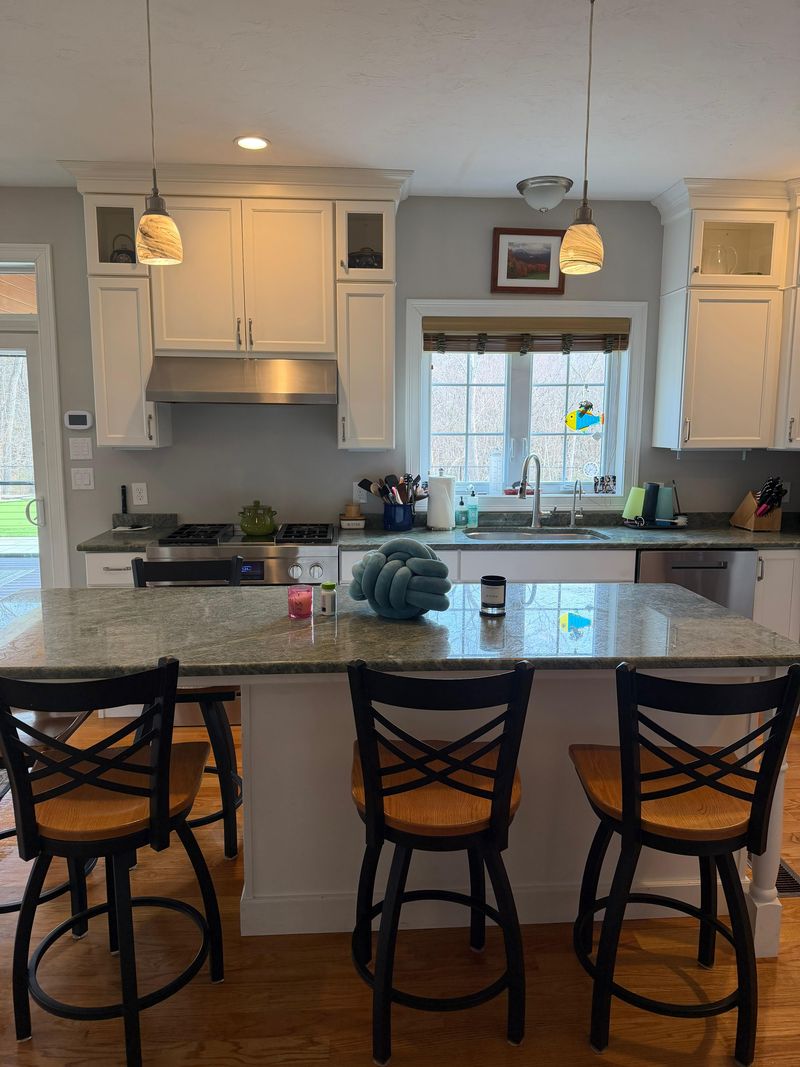 A kitchen with island seating reset after a regular clean