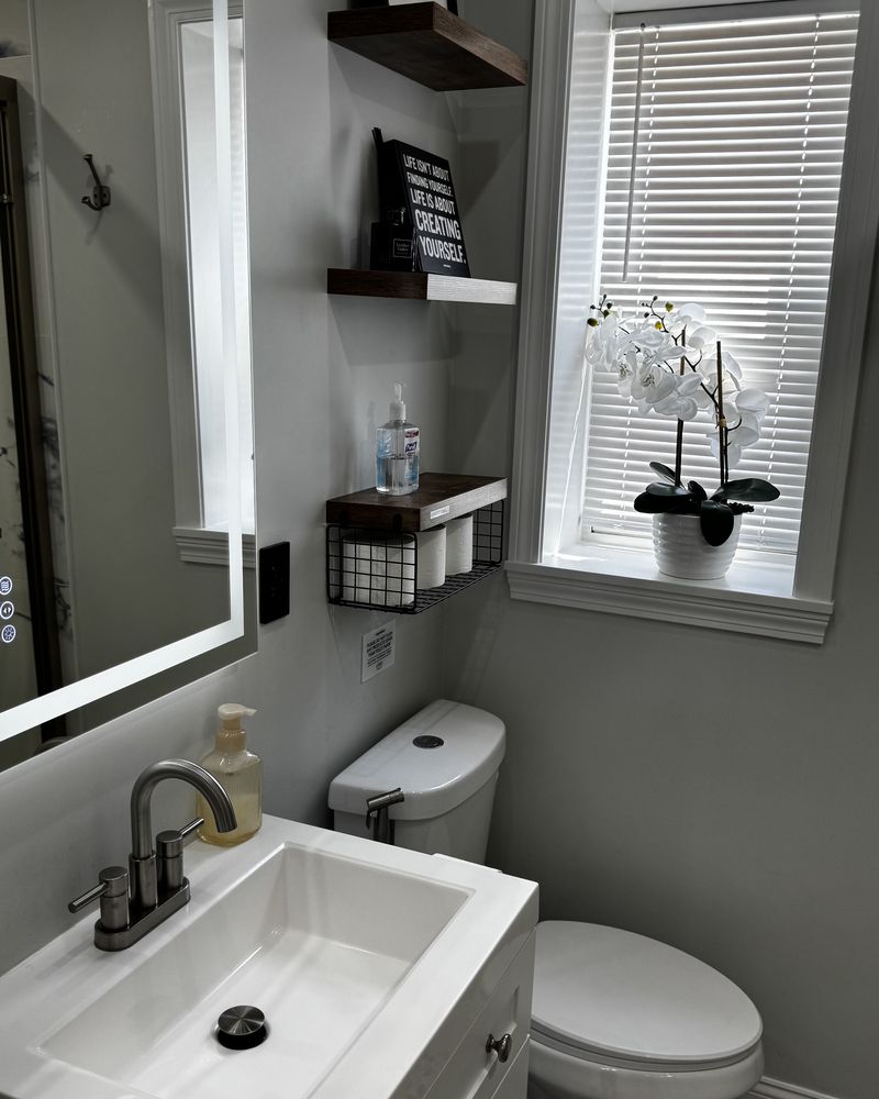 A bathroom vanity, mirror and patterned floor after cleaning