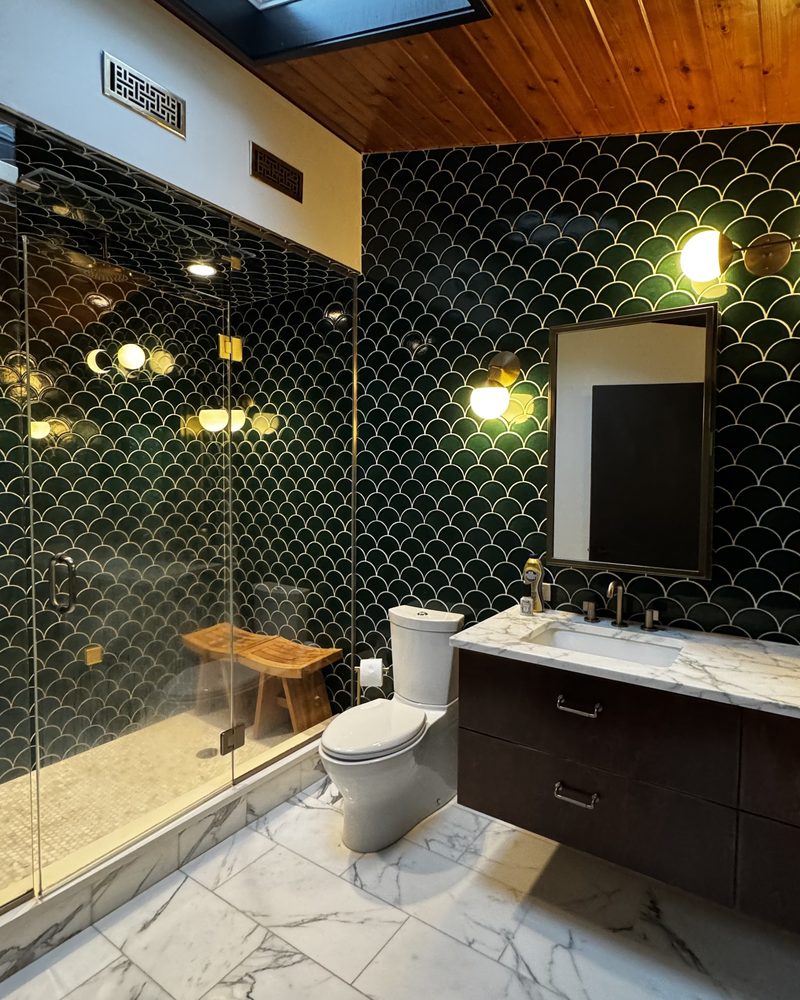 A bathroom with marble floors cleaned top to bottom